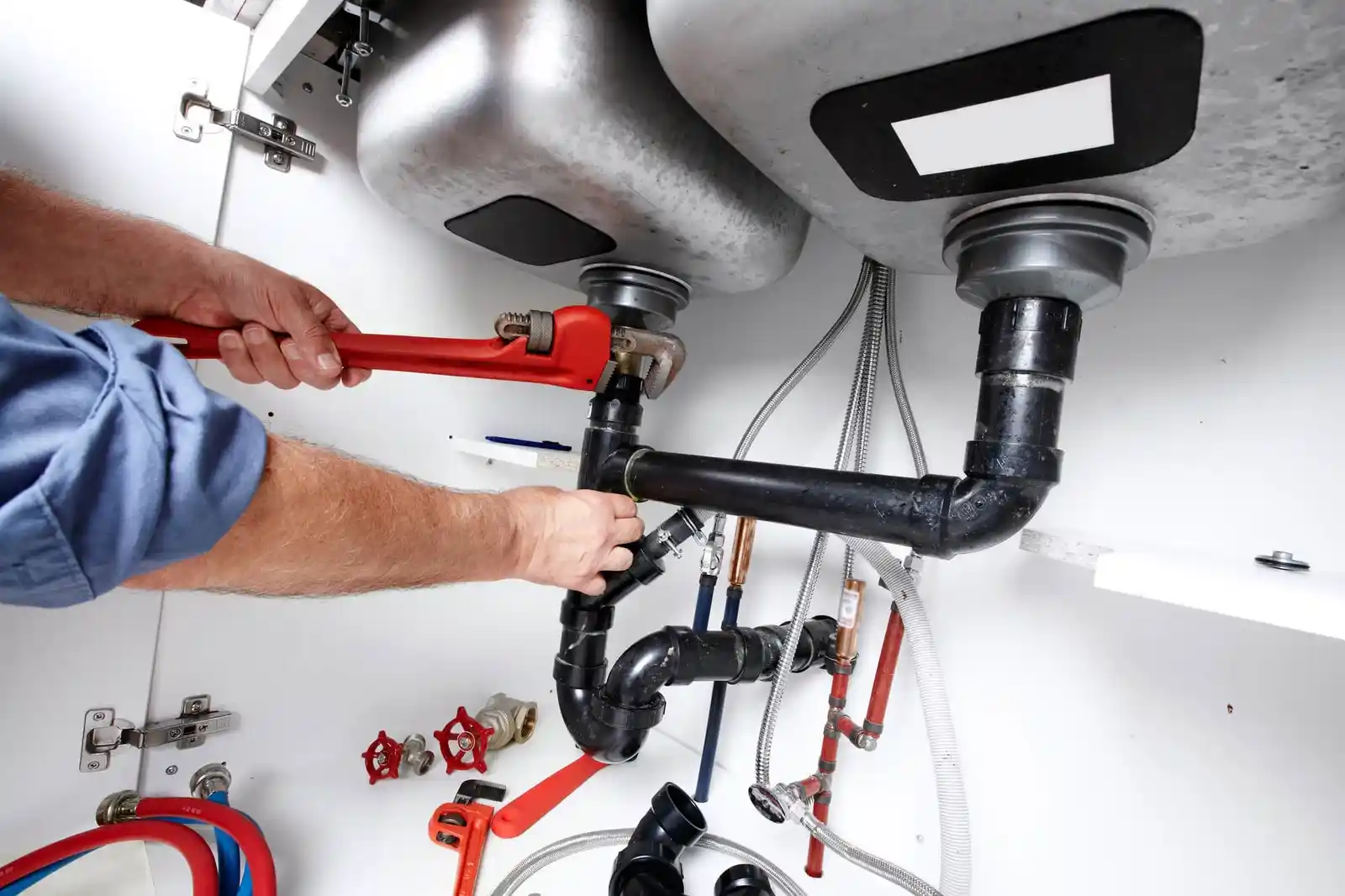 plumber fixing sink pipe